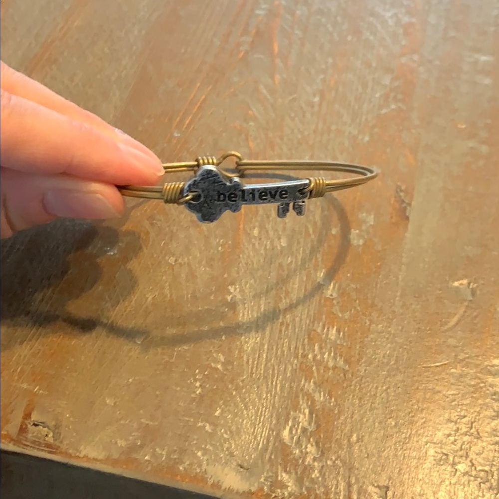 Brushed bronze bracelet that says "believe"